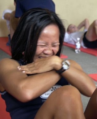 U.S. Air Force CAPT. Mon Morris, of the 36th Mission Support Squadron, struggles to get a few more sit ups before her time is up during the Fit to Fight portion of the Team Andersen Challenge at Andersen Air Force Base, Guam, on Feb. 25, 2005. (U.S. Air Force PHOTO by AMN Teresa M. Pumphrey) (Released)