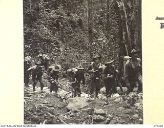 KANKIRYO SADDLE, FINISTERRE RANGE, NEW GUINEA, 1944-02-15. MEMBERS OF "B" COMPANY, 57/60TH INFANTRY BATTALION MOVING UP KANKIRYO SADDLE ALONG STEPS CUT BY THE 2/9TH BATTALION. "B" COMPANY IS ON THE ..