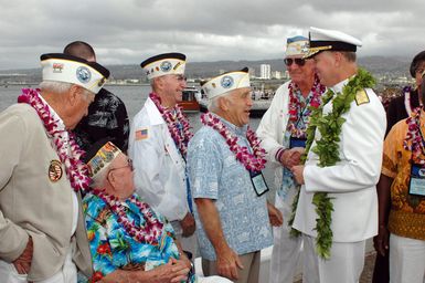 U.S. Navy Adm. Gary Roughead (right), Commander, U.S. Pacific Fleet, speaks with Pearl Harbor survivors at Pearl Harbor, Hawaii, on Dec. 7, 2006, during the joint Navy/National Park Service ceremony commemorating the 65th Anniversary of the attack on Pearl Harbor. More than 1,500 Pearl Harbor survivors, their families and their friends from around the nation joined the more than 2,000 distiguished guests and the general public for the annual Pearl Harbor observance. (U.S. Navy photo by CHIEF Communication SPECIALIST Don Bray) (Released)