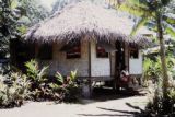 French Polynesia, women sitting on steps of home on Tahiti Island