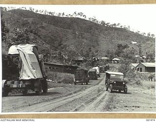 PORT MORESBY, NEW GUINEA. 1943-12-07. SEARCHLIGHTS AND GENERATORS JUST ARRIVED AT NO. 3 SUB DEPOT, 10TH AUSTRALIAN ADVANCED ORDNANCE DEPOT WAITING TO BE SHIFTED TO THE STORAGE AREAS