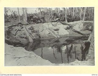 HANSA BAY, NEW GUINEA. 1944-06-17. JAPANESE ARMY TRUCKS WHICH JUST MISSED A DIRECT HIT BY A LARGE ALLIED AERIAL BOMB