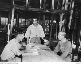 KAVIENG, NEW IRELAND. 1945-10-20. REAR-ADMIRAL TAMURa, JAPANESE IMPERIAL NAVY, IN CONFERENCE WITH CAPTAIN F.N.W. SHAND, AUSTRALIAN NEW GUINEA ADMINISTRATIVE UNIT DISTRICT OFFICER. THE JAPANESE ..