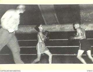 LAE, NEW GUINEA. 1944-07-22. AUSTRALIAN SERVICE PERSONNEL STAGING AN EXHIBITION MATCH DURING A BOXING TOURNAMENT BETWEEN AUSTRALIAN AND AMERICAN SERVICEMEN