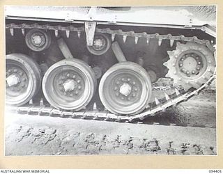 TOROKINA AREA, BOUGAINVILLE. 1945-07-28. AN M24 GENERAL CHAFFEE LIGHT TANK PICTURED DURING TESTS CONDUCTED FOR THE WAR OFFICE. NOTE CLEAN CONDITION OF SUSPENSION OF TRACKS