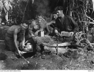 FINSCHHAFEN, NEW GUINEA. 1943-12-25. NX76525 PRIVATE R. W. MCKAY COOK OF THE 2/3RD PIONEER BATTALION INSPECTING A TURKEY COOLING IN AN IMPROVISED OVEN, WHILE OTHER MEMBERS OF THE UNIT ANXIOUSLY ..