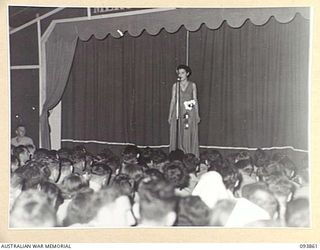 LAE AREA, NEW GUINEA, 1945-07-09. SIGNALWOMAN N.L. EADE, SOLOIST, TAKING PART IN THE 19 LINES OF COMMUNICATION AREA SIGNALS REVUE "OVER TO YOU" IT WAS HELD AT THE UNIT'S RECREATION HUT WHICH WAS ..