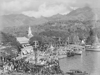 [Moored ships and crowd along Pacific Island waterfront]