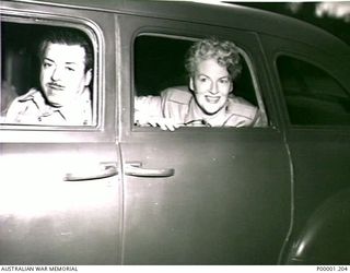 THE SOLOMON ISLANDS, 1945-08. BRITISH ENTERTAINER GRACIE FIELDS AND HER HUSBAND MONTY BANKS DEPARTING AFTER AN AUSTRALIAN THANKSGIVING SERVICE ON BOUGAINVILLE ISLAND. (RNZAF OFFICIAL PHOTOGRAPH.)