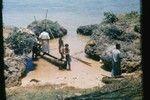 [Group with outrigger canoe]