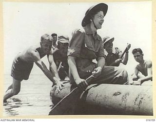 NEW GUINEA. 1943-11-19. RED CROSS WORK AT A PICNIC HELD FOR CONVALESCENTS AT AN AUSTRALIAN FIELD HOSPITAL. SISTERS AND CONVALESCENTS SET OFF IN A RUBBER BOAT
