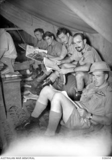 MILNE BAY, PAPUA. 1942-09. BOMBER AND FIGHTER PERSONNEL OF RAAF SQUADRONS TAKE IT EASY. LEFT TO RIGHT:- FLIGHT-SERGEANT A.W. MALCOLM, (HUDSON SQUADRON), FLIGHT-SERGEANT W.R. SWANSON (HUDSON ..