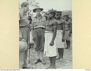 FINSCHHAFEN AREA, NEW GUINEA. 1944-04-25. THE HONOURABLE E.J. WARD, MINISTER FOR EXTERNAL TERRITORIES IN THE AUSTRALIAN GOVERNMENT (3), WITH NX70327 MAJOR A.M. ALISON (1), AND LULULAI CHIEF ..