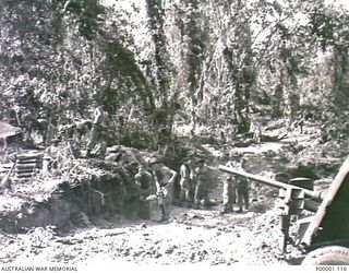 THE SOLOMON ISLANDS, 1945-04-24/27. AUSTRALIAN ARTILLERYMEN ON BOUGAINVILLE ISLAND FILLING SANDBAGS DURING CONSTRUCTION OF THEIR GUN POSITIONS. (RNZAF OFFICIAL PHOTOGRAPH.)