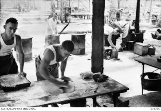 SIAR-NAGADA, NEW GUINEA. 1944-09-08. COOKS OF HEADQUARTERS COMPANY, 61ST INFANTRY BATTALION, "THE QUEENSLAND CAMERON HIGHLANDERS," COOKING DINNER FOR THE TROOPS. IDENTIFIED PERSONNEL ARE:- Q107865 ..