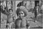 Adolescent boys with pierced noses, one in barkcloth cap, stand near the Rappaports' house