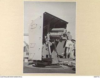 MIOS WUNDI HARBOUR, DUTCH NEW GUINEA. 1944-11-15. THE FORWARD 4 INCH GUN ABOARD HMAS STAWELL