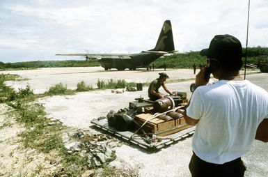 Air Force personnel prepare to board the last C-130 Hercules aircraft back to Guam, after four days of directing other C-130s in and offloading them for the Navy seabees, who will stay to participate in Exercise Kennel Bear '4-82