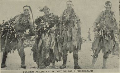 Soldiers assume native costume for a photograph