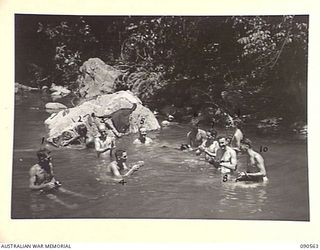 WONGINARA MISSION, NEW GUINEA. 1945-04-07. PERSONNEL OF 2/3 INFANTRY BATTALION WASHING IN THE MABAM CREEK WHICH RUNS BY THE CAMP. (FOR IDENTIFICATION OF 10 NAMED PERSONNEL REFER TO PROVISIONAL ..