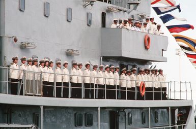 Crew members of the visiting Chinese training vessel ZHENG HE man the rail