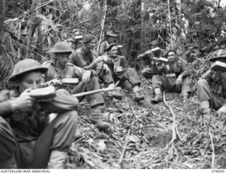 BOUGAINVILLE ISLAND. 1944-12-30. TROOPS OF D COMPANY, 25TH INFANTRY BATTALION ENJOY A CUP OF TEA ON THE TRACK TO PEARL RIDGE DURING A LULL IN THE FIGHTING IN THE AUSTRALIAN ATTACK ON JAPANESE ..