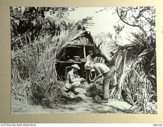 MENDAROPU, NEW GUINEA. 1942-11. A COOKHOUSE SET UP ON THE EDGE OF THE JUNGLE NEAR THE VILLAGE BY MEMBERS OF A UNITED STATES INFANTRY UNIT