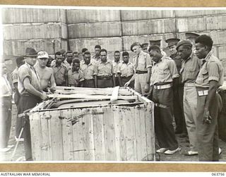 1944-01-26. AUSTRALIAN AND NEW GUINEA ADMINISTRATION UNIT NATIVES WATCHING A JEEP CHASSIS BEING UNPACKED AT THE FACTORY OF THE FORD MOTOR COMPANY