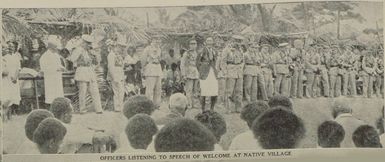 Officers listening to speech of welcome at native village