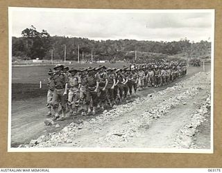 DONADABU, PAPUA, NEW GUINEA. 1944-01-01. THE GRAND MARCH BY THE 57/60TH INFANTRY BATTALION LED BY THE COMMANDING OFFICER OF UNIT IN PROGRESS AT THE START OF THE 15TH INFANTRY BRIGADE GYMKHANA. ..