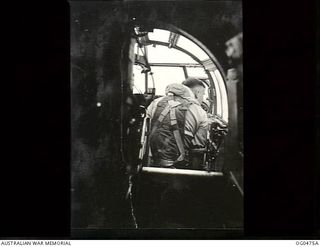 NEW GUINEA. 1944-01-17. STRIKING DAYLIGHT RAIDS BY BEAUFORT BOMBERS ON NEW BRITAIN TARGETS. "BOMBS GONE" FLYING OFFICER B. TAYLOR, OBSERVER IN BEAUFORT PILOTED BY FLYING OFFICER A. HARRISON TURNS ..