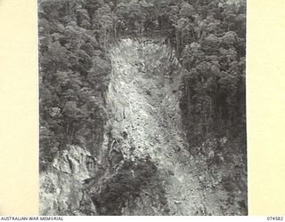 NEW GUINEA. 1944-07-09. A BAD LANDSLIDE ALONG THE PATH OF THE NEW WAU-BULLDOG ROAD NEAR EDIE CREEK