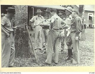 KOITAKI, NEW GUINEA. 1944-04-19. THE HONOURABLE E.J. WARD, MINISTER FOR EXTERNAL TERRITORIES IN THE AUSTRALIAN GOVERNMENT (4), PICTURED WITH OFFICIALS INSPECTING A RUBBER TREE AT THE KOITAKI RUBBER ..