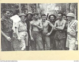 1942-10-08. MR DRAKEFORD (MINISTER FOR AIR) AND MR COLES M.H.R., WITH SOME OF THE NEW GUINEA TROOPS. (NEGATIVE BY BOTTOMLEY)