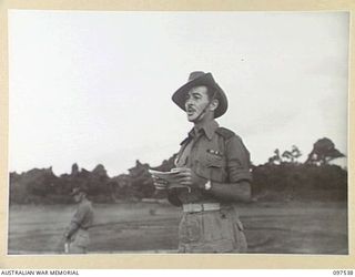 TOROKINA, BOUGAINVILLE. 1945-10-06. LIEUTENANT COLONEL A.J. ANDERSON, COMMANDING OFFICER 24 INFANTRY BATTALION ADDRESSING TROOPS AT THE TOROKINA WAR CEMETERY DURING THE COMMEMORATIVE SERVICE IN ..