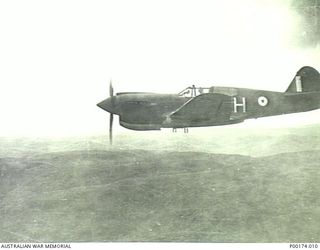 PROBABLY NEW GUINEA C.1940-1942. AN RAAF CURTISS P40 KITTYHAWK IN FLIGHT