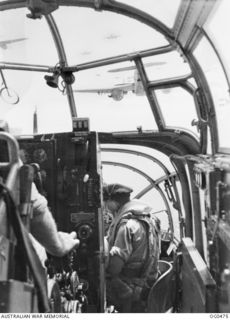 AIRBORNE NEAR LINDENHAFEN, NEW BRITAIN. 1944-01-17. VIEW THROUGH THE NOSE OF A BEAUFORT BOMBER AIRCRAFT OF NO. 100 SQUADRON RAAF, PILOTED BY FLYING OFFICER ALAN HARRISON OF HUON, TAS, WITH FLYING ..