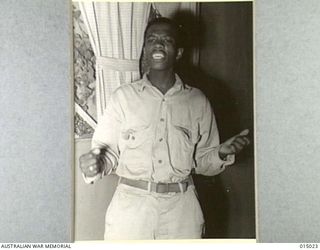 1943-06-15. NEW GUINEA. AT THE OPENING NIGHT OF THE ARMY NEWSPAPER "GUINEA GOLD" MELODY PARADE TALENT QUEST. FIRST HEAT WAS WON BY U.S. PTE. WILLIAM SMITH. AWARDS WERE WON BY VOTING. PTE. SMITH ..