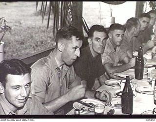 LAE, NEW GUINEA, 1945-12-25. MEMBERS OF FIRST ARMY ENJOYING THEIR CHRISTMAS DINNER IN THE NO 1 OTHER RANKS' MESS