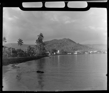 Apia waterfront, Upolu, Samoa, showing beach, palm trees and buildings