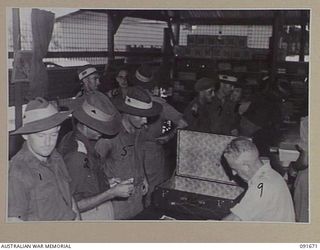 TOROKINA, BOUGAINVILLE. 1945-05-07. GENERAL VIEW OFFICERS MAKING PURCHASES AT 4 SECTION OFFICERS' SHOP. THEY ARE BEING ATTENDED TO BY CORPORAL F.T. NOON (9)