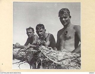 WEST WEWAK BEACH, NEW GUINEA. 1945-09-01. WAR CORRESPONDENTS ATTACHED HEADQUARTERS 6 DIVISION RESTING ON THE BEACH AFTER REPORTING THE AITAPE-WEWAK OPERATIONS. IDENTIFIED PERSONNEL ARE:- MR L. ..