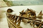 Rusting hulk of a Japanese supply barge on shores of Rabaul Harbour, Apr 1965