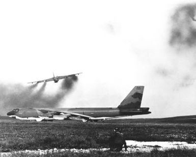 A B-52D Stratofortress aircraft, from Strategic Air Command, leave a smoke trail behind as they take off, one after another, for bombing missions over North Vietnam during Operation LINEBACKER