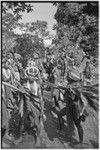 Pig festival, stake-planting, Tuguma: decorated Tsembaga men with ritual items to expel enemy spirits and establish boundary