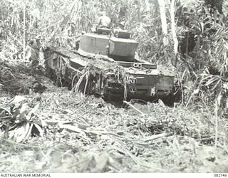 A Churchill IV tank sliding on a rock face at the end of Course no. 1 during tests conducted at HQ 4 Armoured Brigade