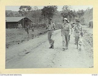 FINSCHHAFEN AREA, NEW GUINEA. 1944-04-25. THE HONOURABLE E.J. WARD, MINISTER FOR EXTERNAL TERRITORIES IN THE AUSTRALIAN GOVERNMENT (1), ACCOMPANIED BY MAJOR-GENERAL B.M. MORRIS, DSO, GOC AUSTRALIAN ..