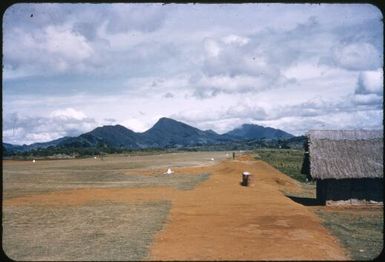 Tari airstrip with the first house built at the site, Tari, Papua New Guinea, ca. 1951 / Albert Speer