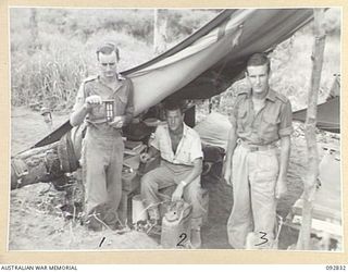 WEWAK AREA, NEW GUINEA. 1945-06-05. WARRANT OFFICER C.J. PADDICK, 3 MOBILE METEOROLOGICAL FLIGHT, RAAF, ATTACHED HEADQUARTERS ROYAL AUSTRALIAN ARTILLERY 6 DIVISION (1), READING THE PSYCHROMETER. ..