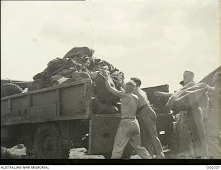 PAPUA-NEW GUINEA. C. 1942-12. UNLOADING RAAF PARCEL MAIL OFF THE TRUCK WHICH HAS ALREADY ARRIVED AT ADVANCED BASES IN THE NEW GUINEA AREA. ALL RAAF POST OFFICE STAFF ARE NOW WORKING LONG, ARDUOUS ..